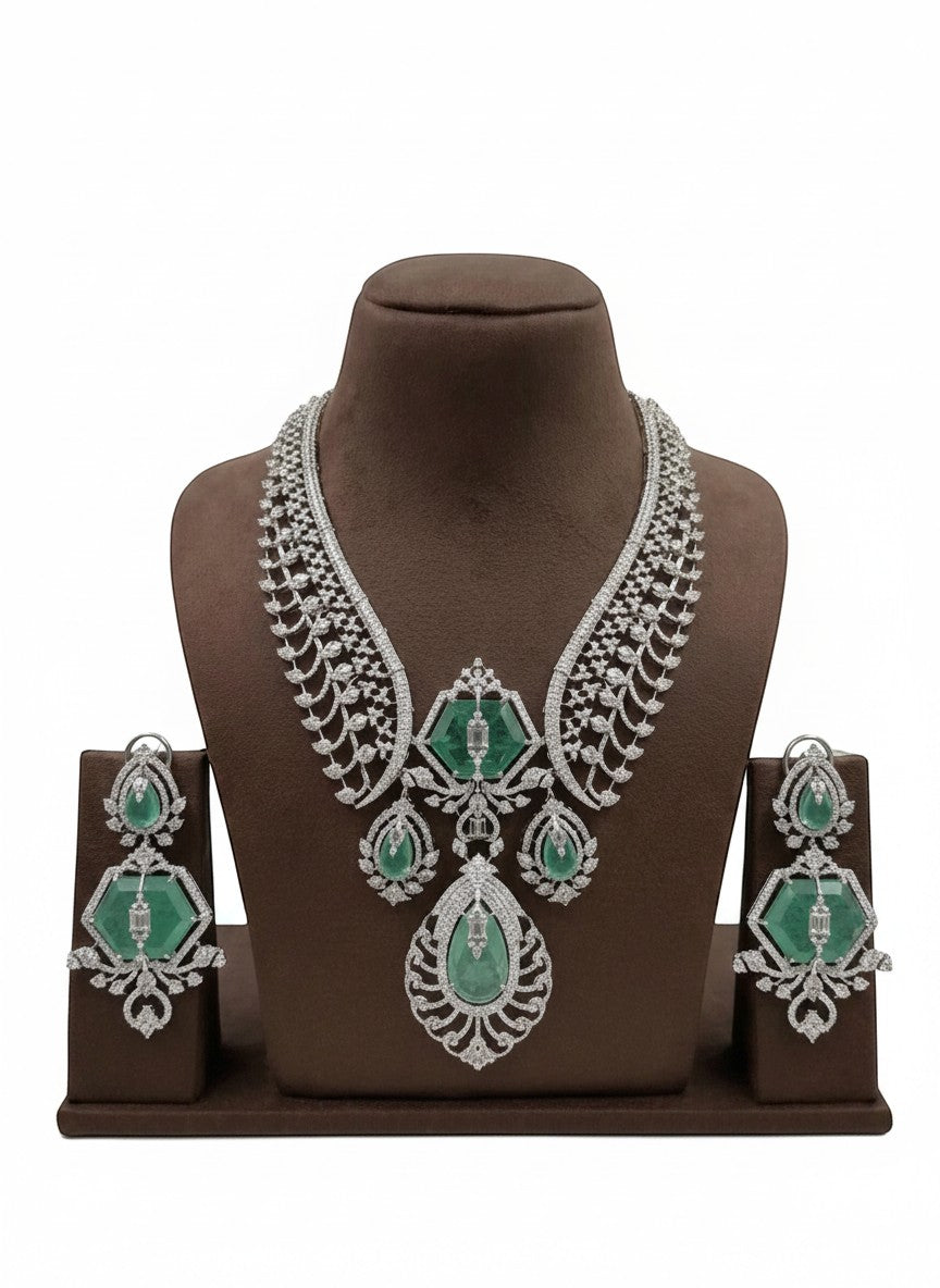 Shyama Fancy Jewellery emerald and diamond necklace set with matching earrings. Intricate white gold setting with large emeralds and sparkling diamonds.