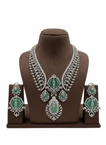 Shyama Fancy Jewellery emerald and diamond necklace set with matching earrings. Intricate white gold setting with large emeralds and sparkling diamonds.