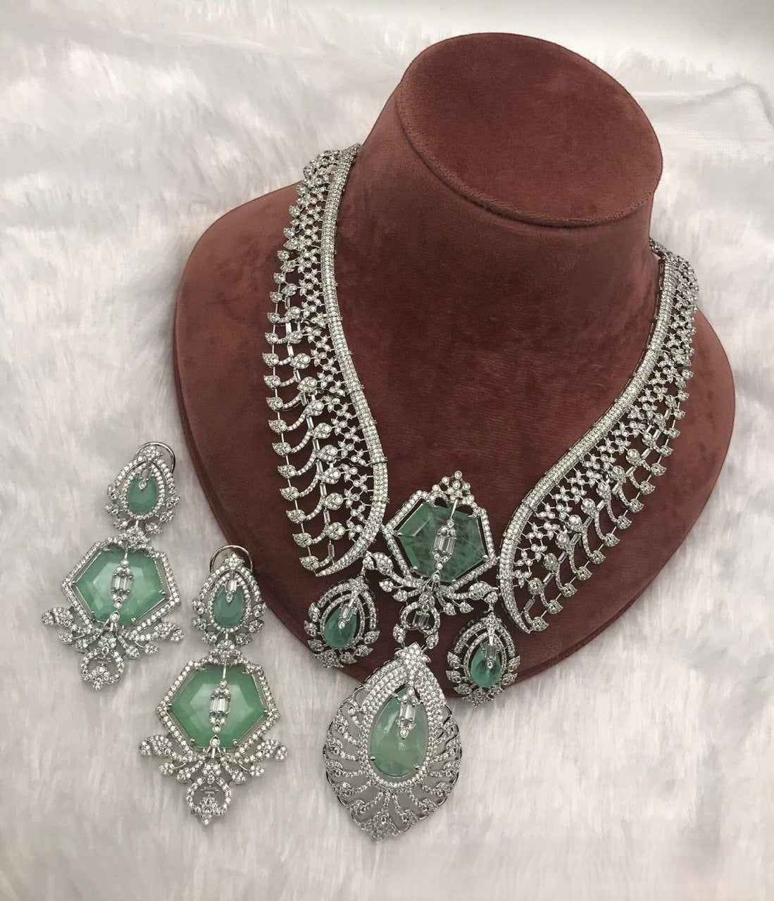 Shyama Fancy Jewellery Jaipuri Moissanite Kundan necklace and earrings set with green stones and intricate silver detailing.